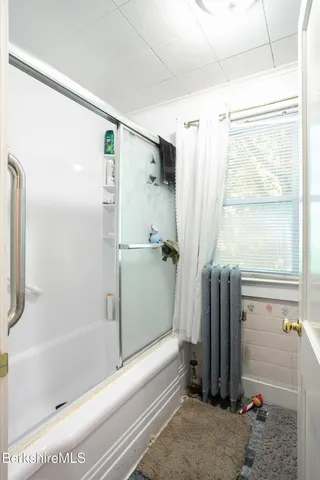 a bathroom with a shower and a tub