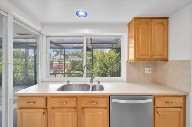 a kitchen with a sink and large window