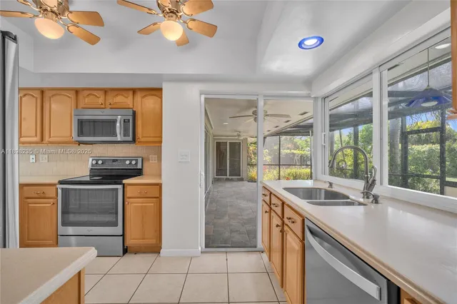 a kitchen with stainless steel appliances granite countertop a sink and a stove