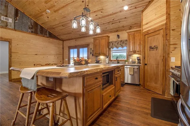 a kitchen with a table chairs refrigerator and cabinets
