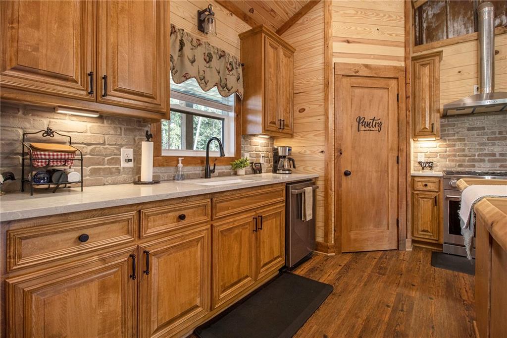 111 Possum Trot Road Barnesville, GA 30204 - Photo 14 of 54 a kitchen with stainless steel appliances a sink and cabinets