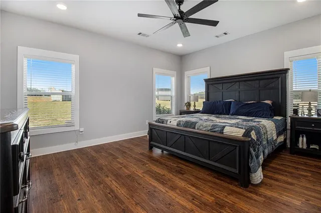 a bedroom with a bed and wooden floor