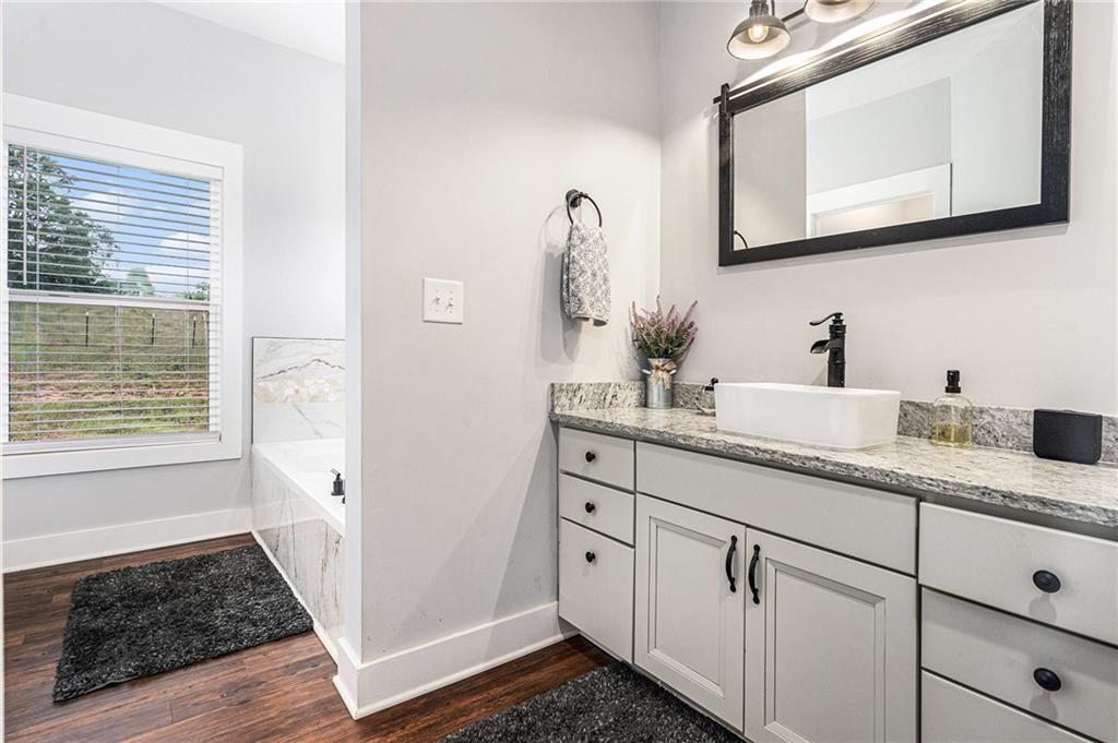 111 Possum Trot Road Barnesville, GA 30204 - Photo 18 of 54 a bathroom with a sink and a mirror