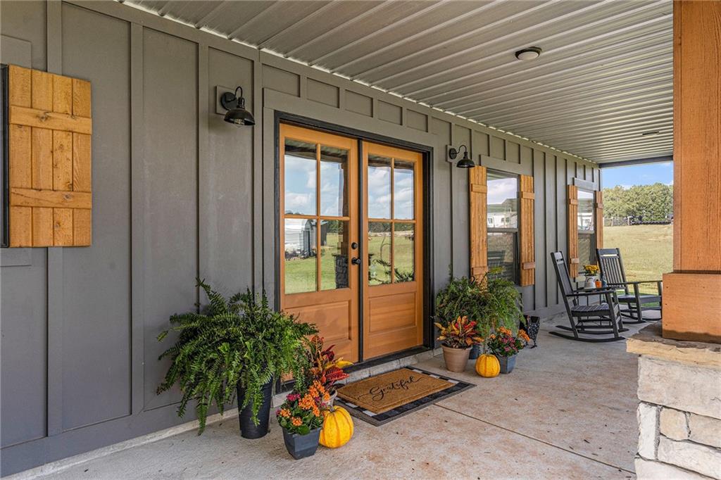 111 Possum Trot Road Barnesville, GA 30204 - Photo 2 of 54 a view of a patio with table and chairs and potted plants next to a window