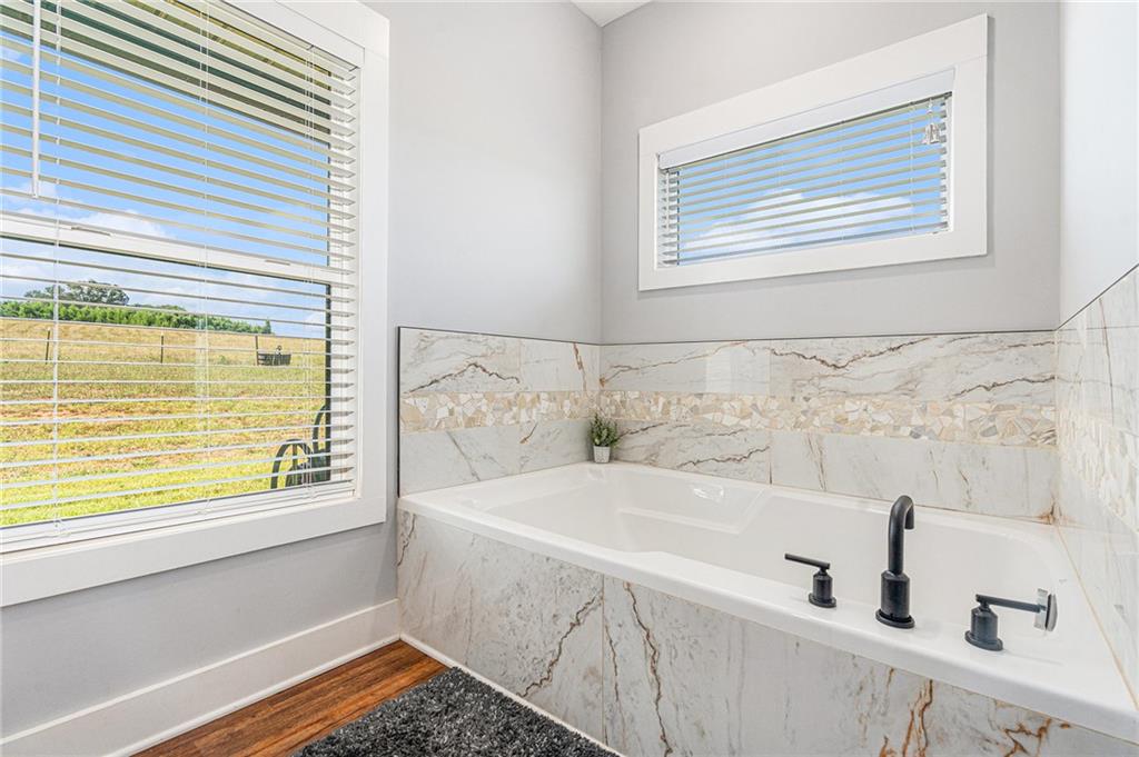 111 Possum Trot Road Barnesville, GA 30204 - Photo 23 of 54 a bathroom with a bathtub and a window