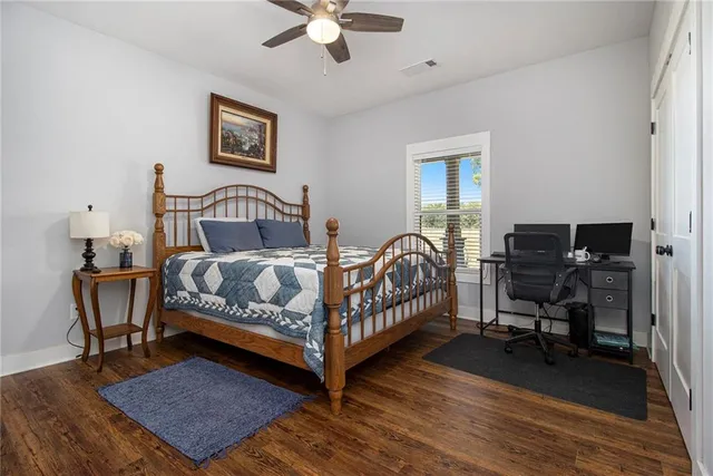 a bedroom with a bed a table and chair