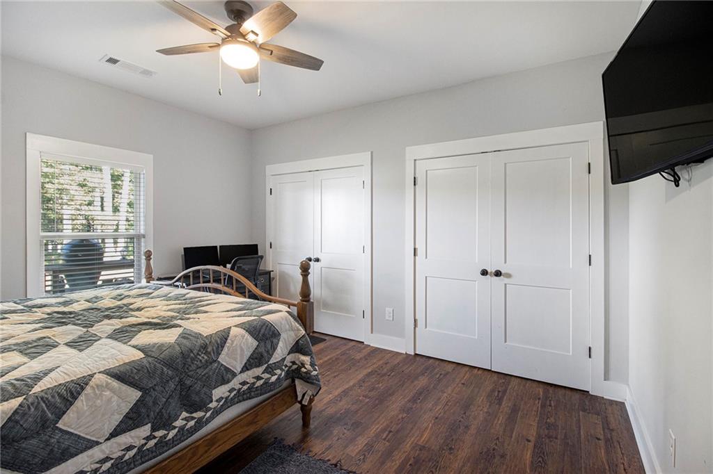 111 Possum Trot Road Barnesville, GA 30204 - Photo 26 of 54 a bedroom with a bed and a chandelier