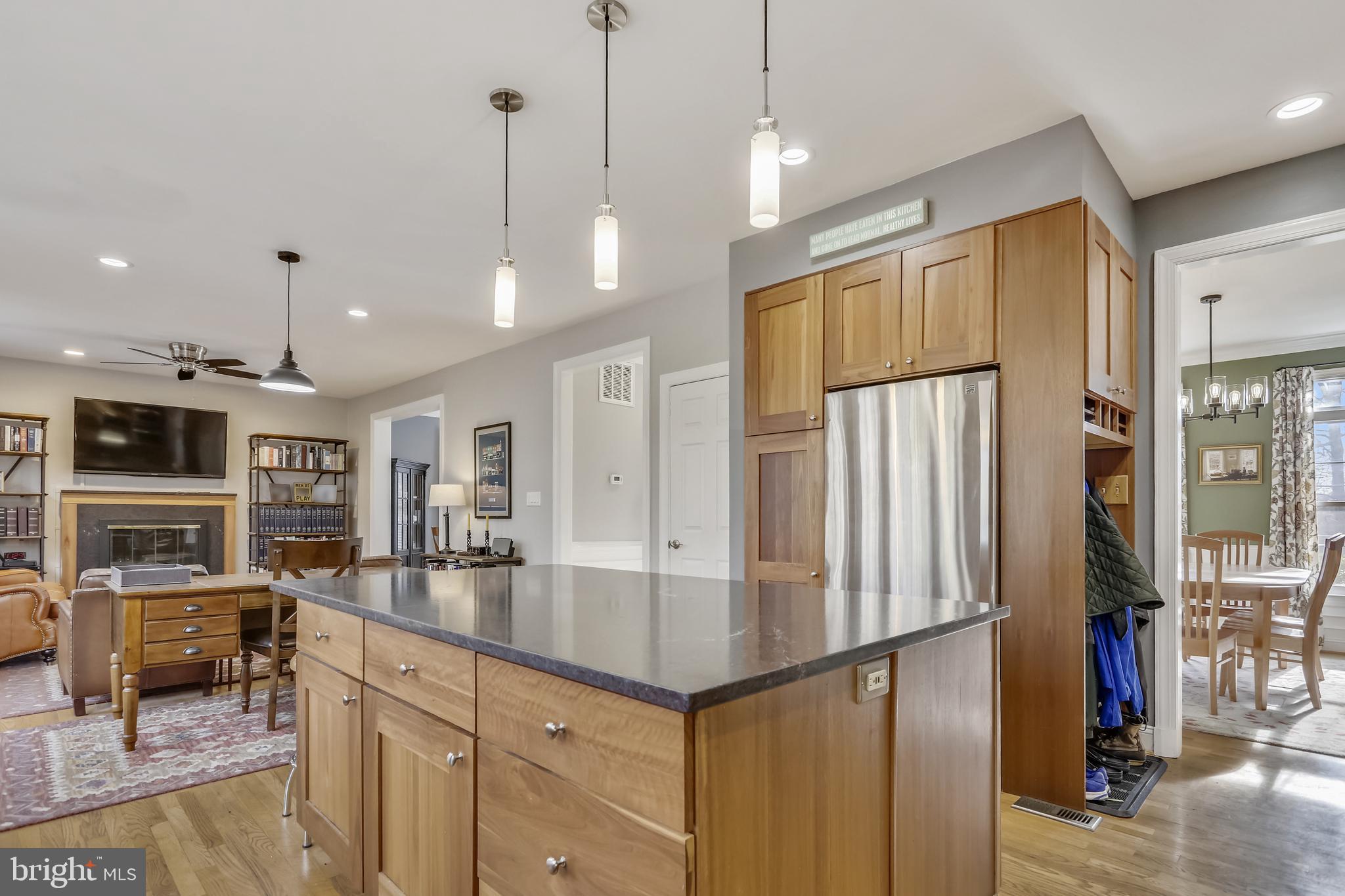 10783 Kinloch Road Silver Spring, MD 20903 - Photo 7 of 43 a kitchen with stainless steel appliances granite countertop a refrigerator a oven and a dining table with wooden floor