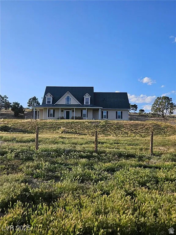29 R7w S4, Unit 22 Beaver, UT 84713 - Photo 6 of 10 View of front of home with covered porch and a front lawn