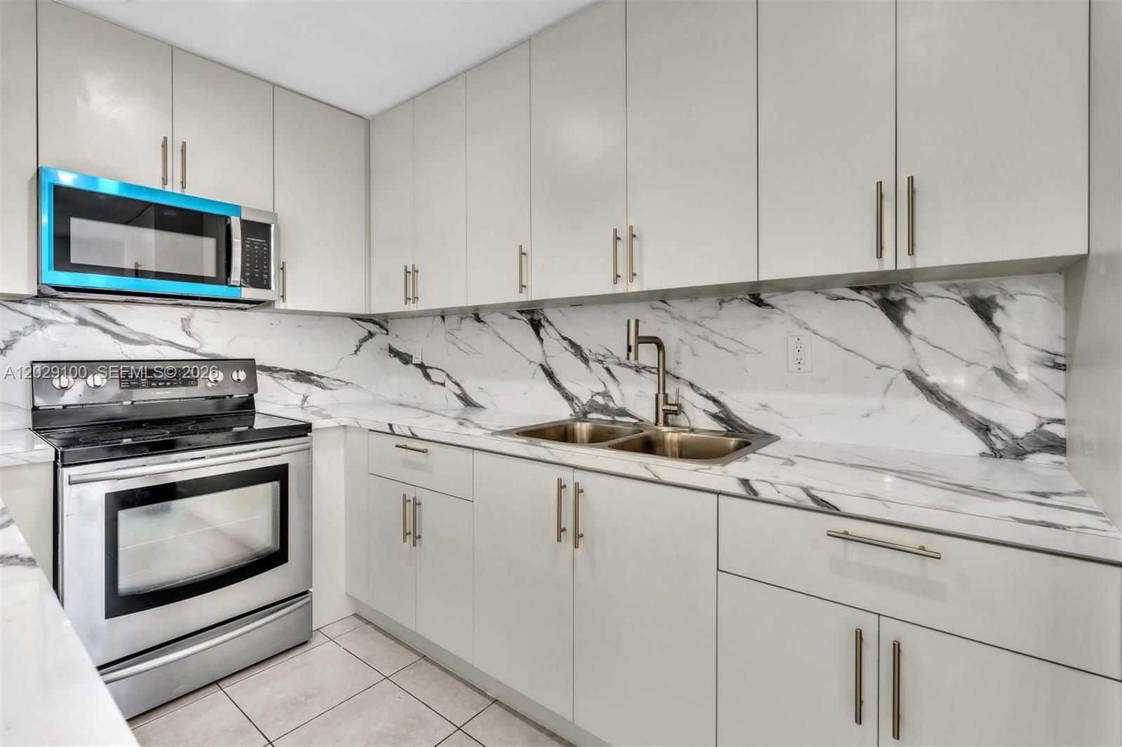 11790 Southwest 34th Street Miami, FL 33175 - Photo 18 of 56 a kitchen with stainless steel appliances granite countertop a sink a stove and microwave