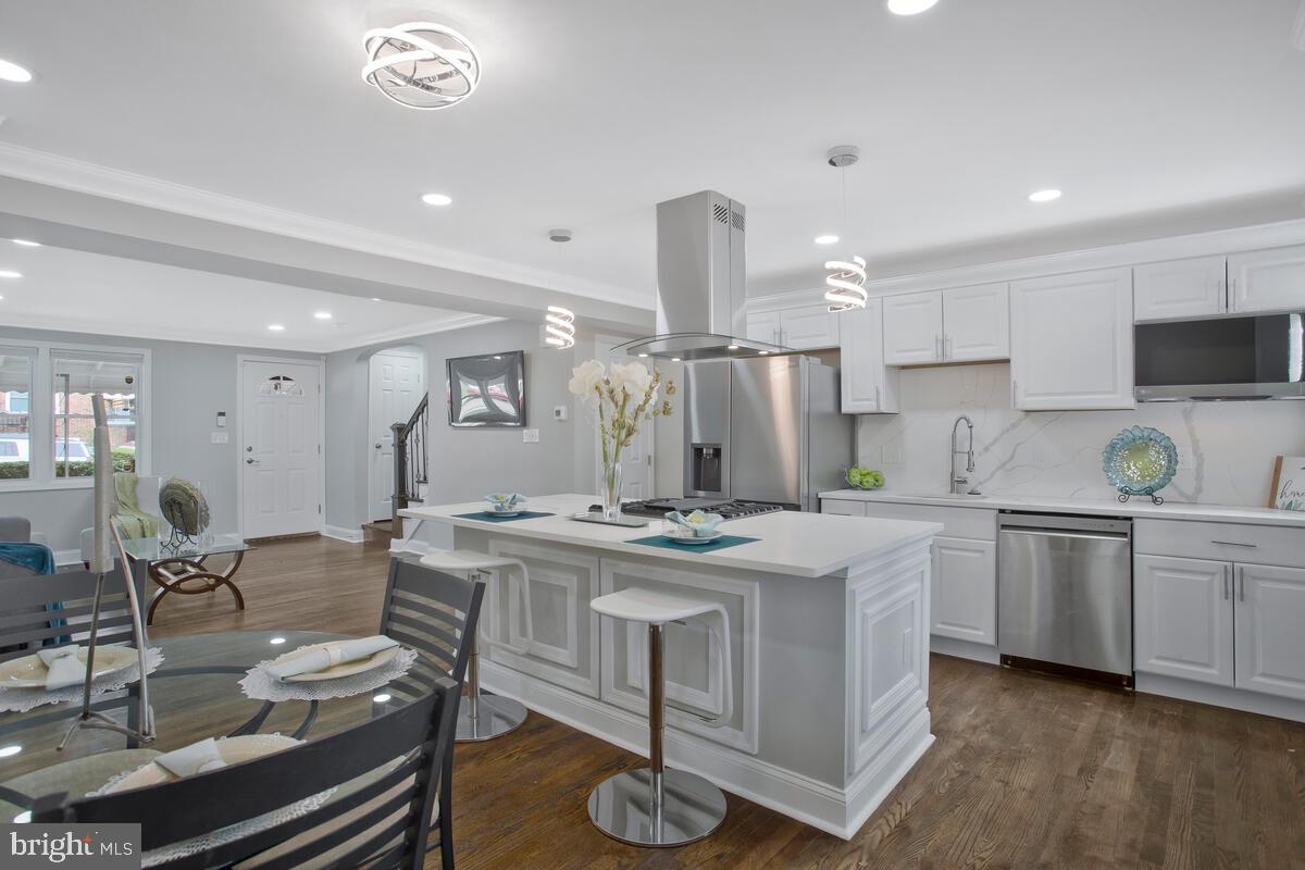 4243 Flowerton Road Baltimore, MD 21229 - Photo 11 of 35 a kitchen with stainless steel appliances granite countertop a stove and a refrigerator