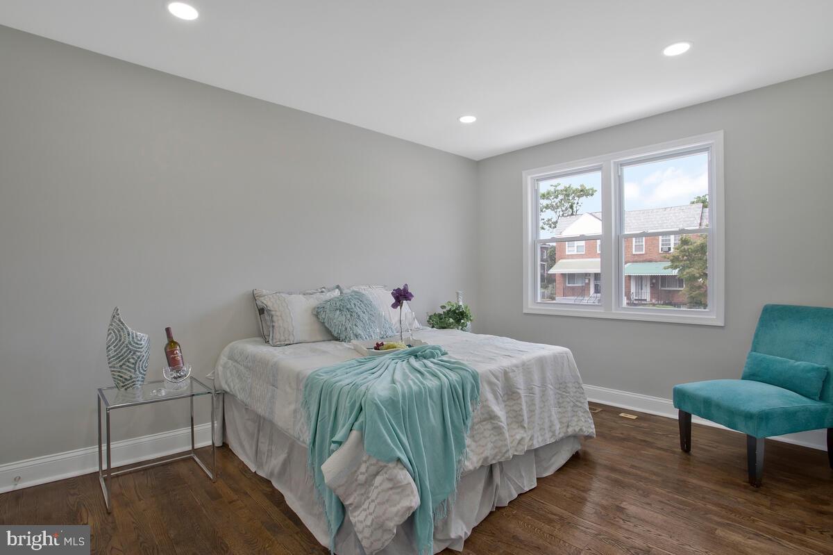 4243 Flowerton Road Baltimore, MD 21229 - Photo 14 of 35 a bedroom with a bed and a chair