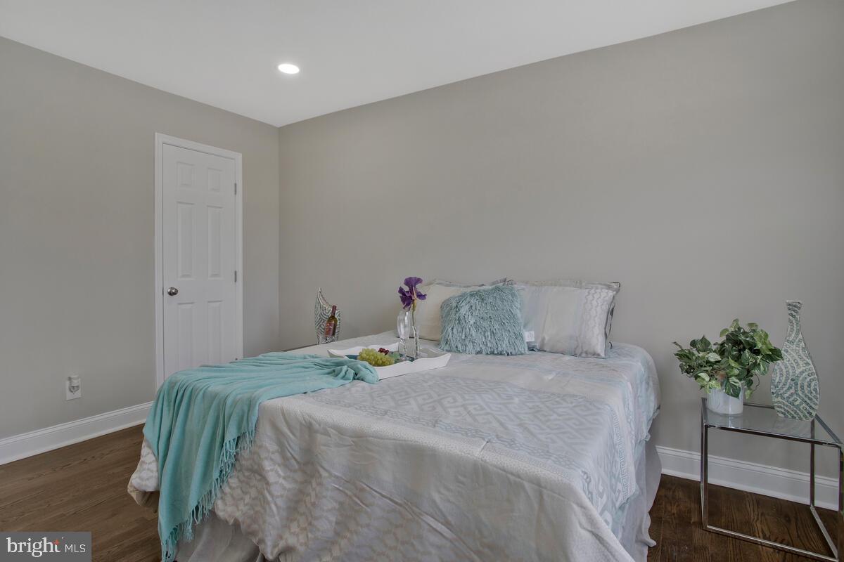 4243 Flowerton Road Baltimore, MD 21229 - Photo 15 of 35 a bedroom with a bed and a potted plant