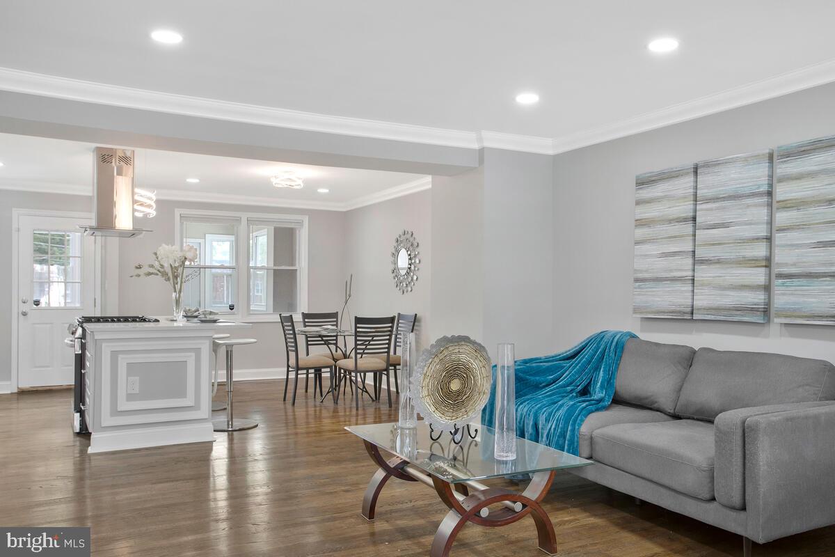 4243 Flowerton Road Baltimore, MD 21229 - Photo 3 of 35 a living room with furniture wooden floor and kitchen view