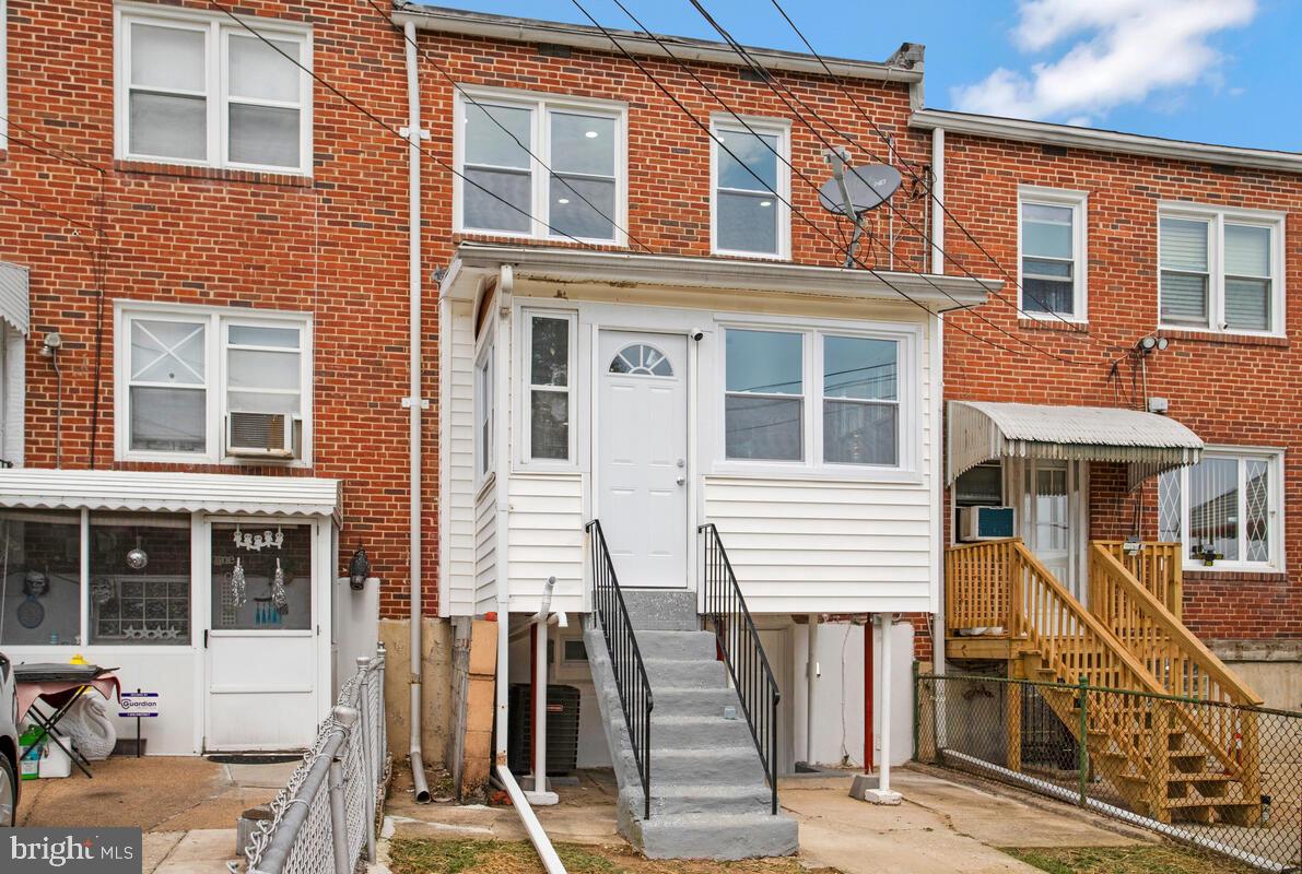 4243 Flowerton Road Baltimore, MD 21229 - Photo 31 of 35 a front view of a house with many windows