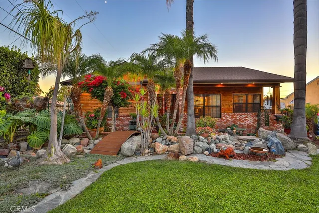 a front view of a house with a yard table and chairs
