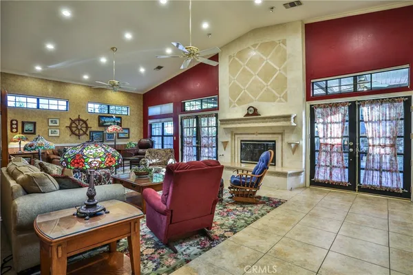 a living room with fireplace furniture and a rug