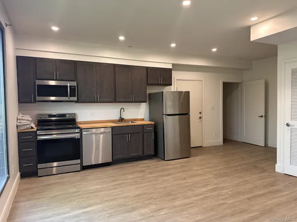a kitchen with stainless steel appliances a refrigerator and a stove top oven