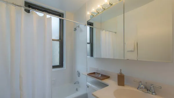 a bathroom with a shower and a sink