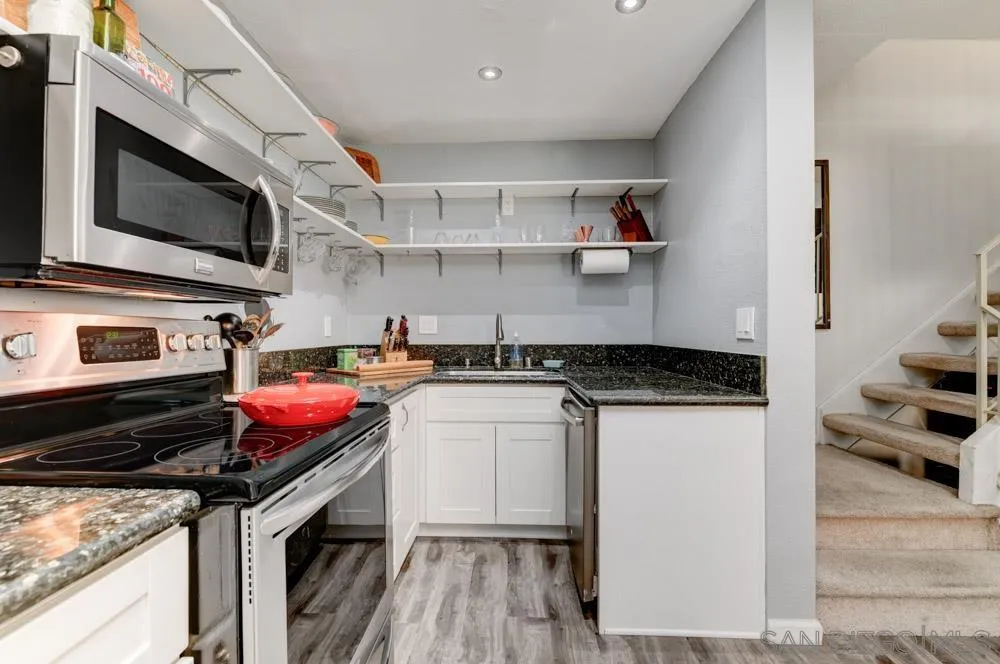 10423 Caminito Rimini San Diego, CA 92129 - Photo 12 of 25 a kitchen with a stove and a microwave