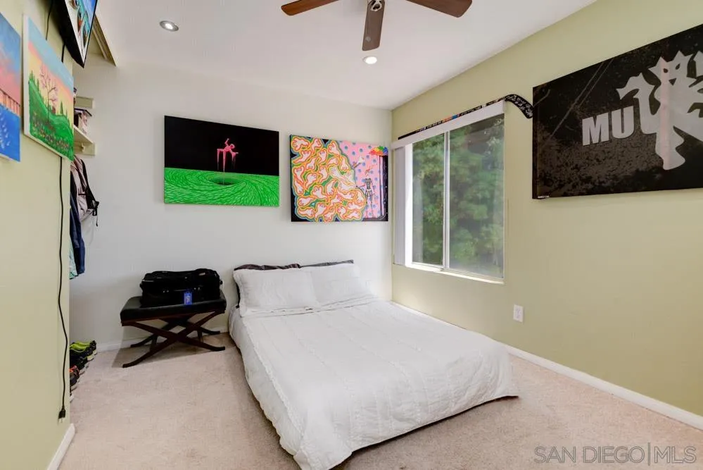 10423 Caminito Rimini San Diego, CA 92129 - Photo 15 of 25 a bedroom with a bed and a window