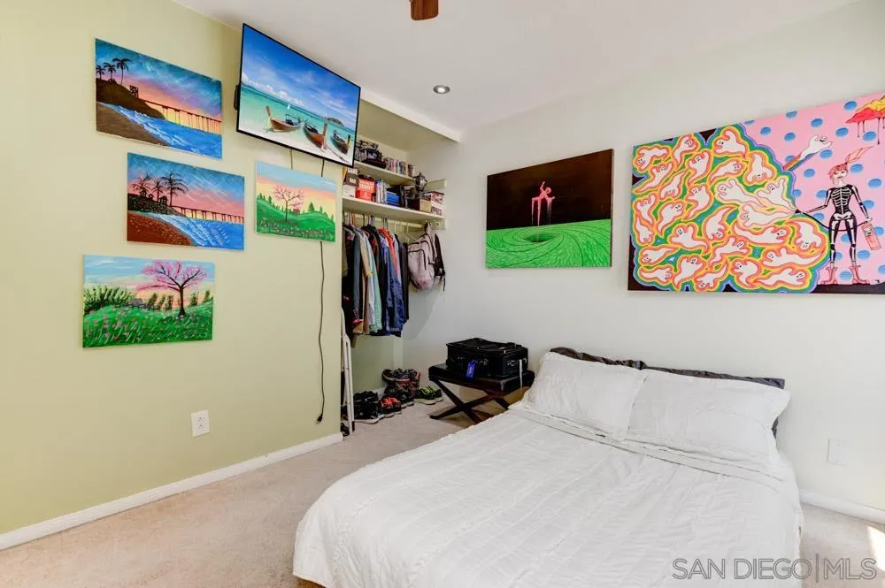 10423 Caminito Rimini San Diego, CA 92129 - Photo 17 of 25 a bedroom with a bed and a flat screen tv