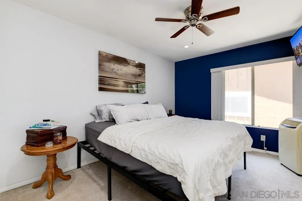 10423 Caminito Rimini San Diego, CA 92129 - Photo 18 of 25 a bedroom with a bed and a chandelier