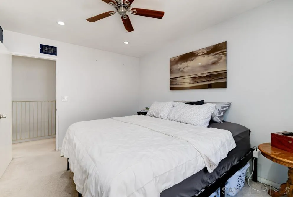 10423 Caminito Rimini San Diego, CA 92129 - Photo 19 of 25 a bedroom with a bed and a painting on the wall