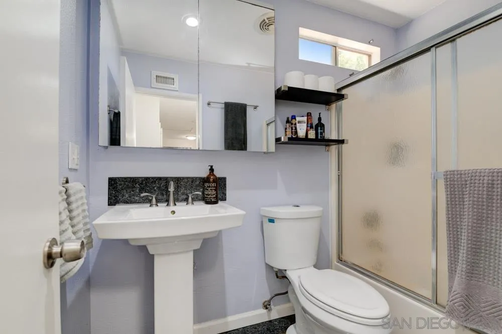 10423 Caminito Rimini San Diego, CA 92129 - Photo 21 of 25 a bathroom with a sink toilet vanity and shower