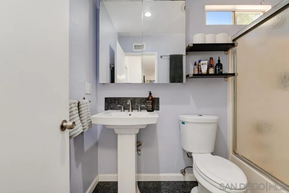 10423 Caminito Rimini San Diego, CA 92129 - Photo 22 of 25 a bathroom with a sink a toilet and shower