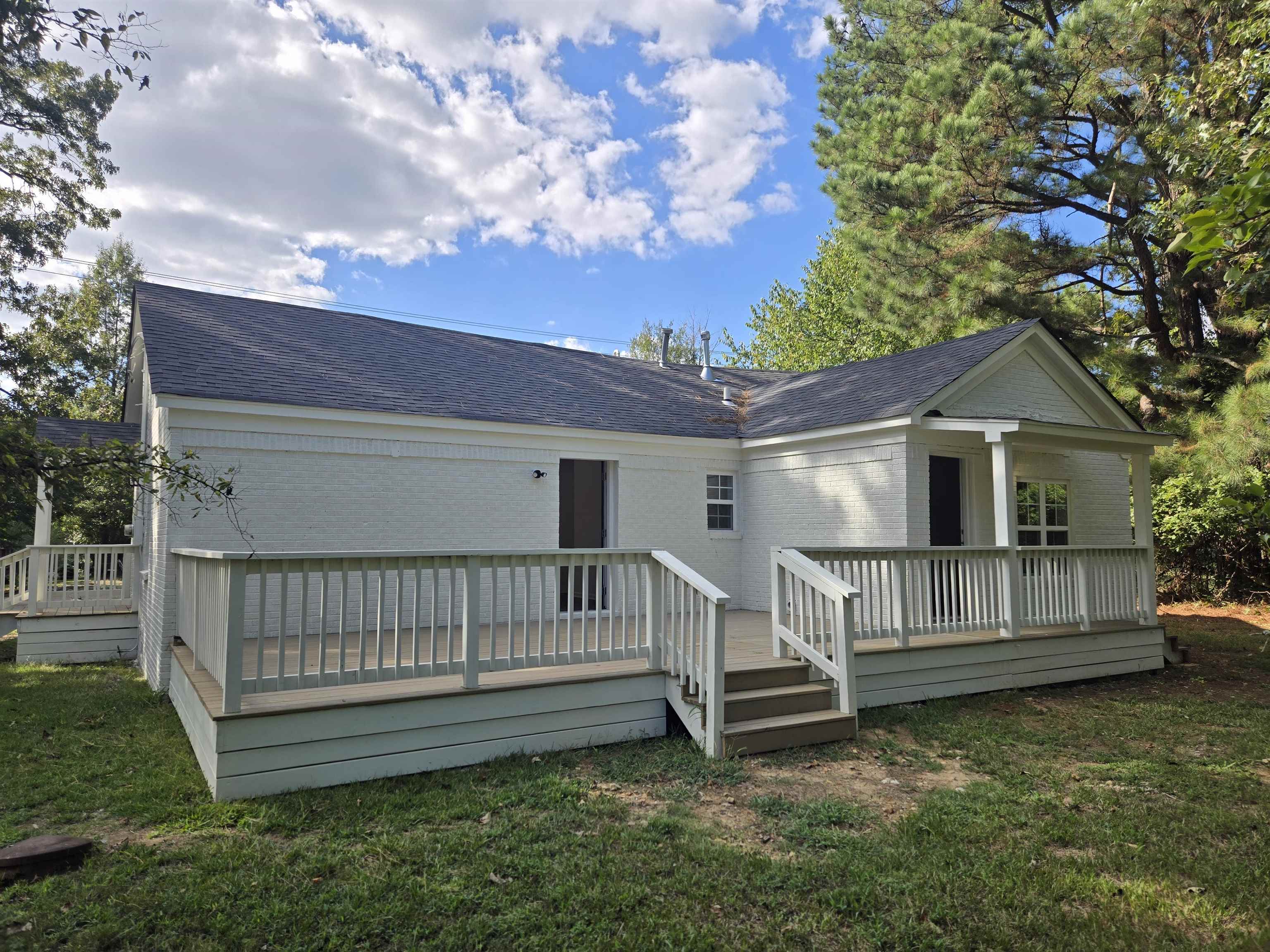 880 Pisgah Road Eads, TN 38028 - Photo 10 of 19 Back of property featuring a shingled roof, a yard, a wooden deck, and brick siding
