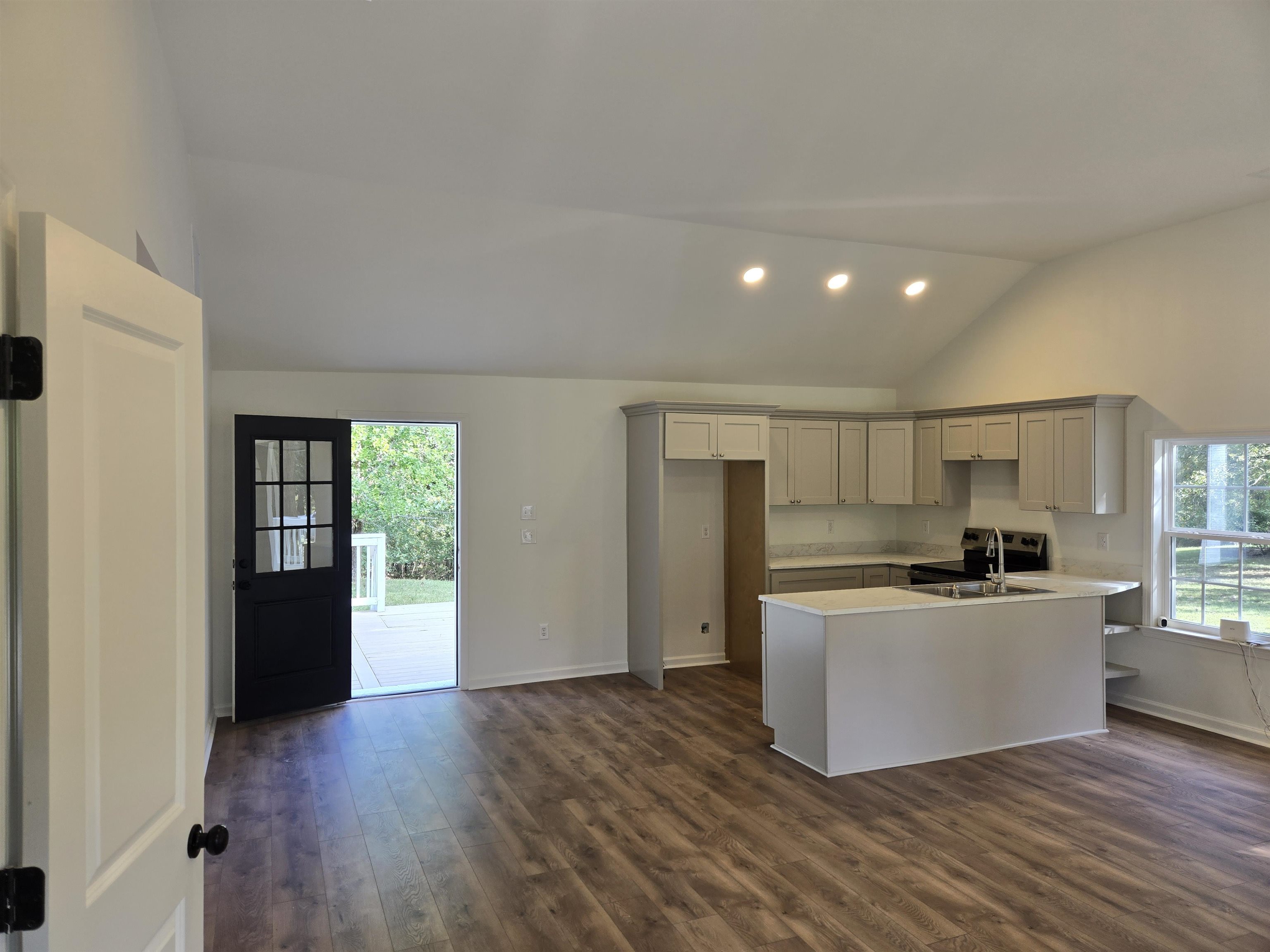 880 Pisgah Road Eads, TN 38028 - Photo 2 of 19 Kitchen featuring a peninsula, dark wood-style flooring, recessed lighting, light countertops, and high vaulted ceiling