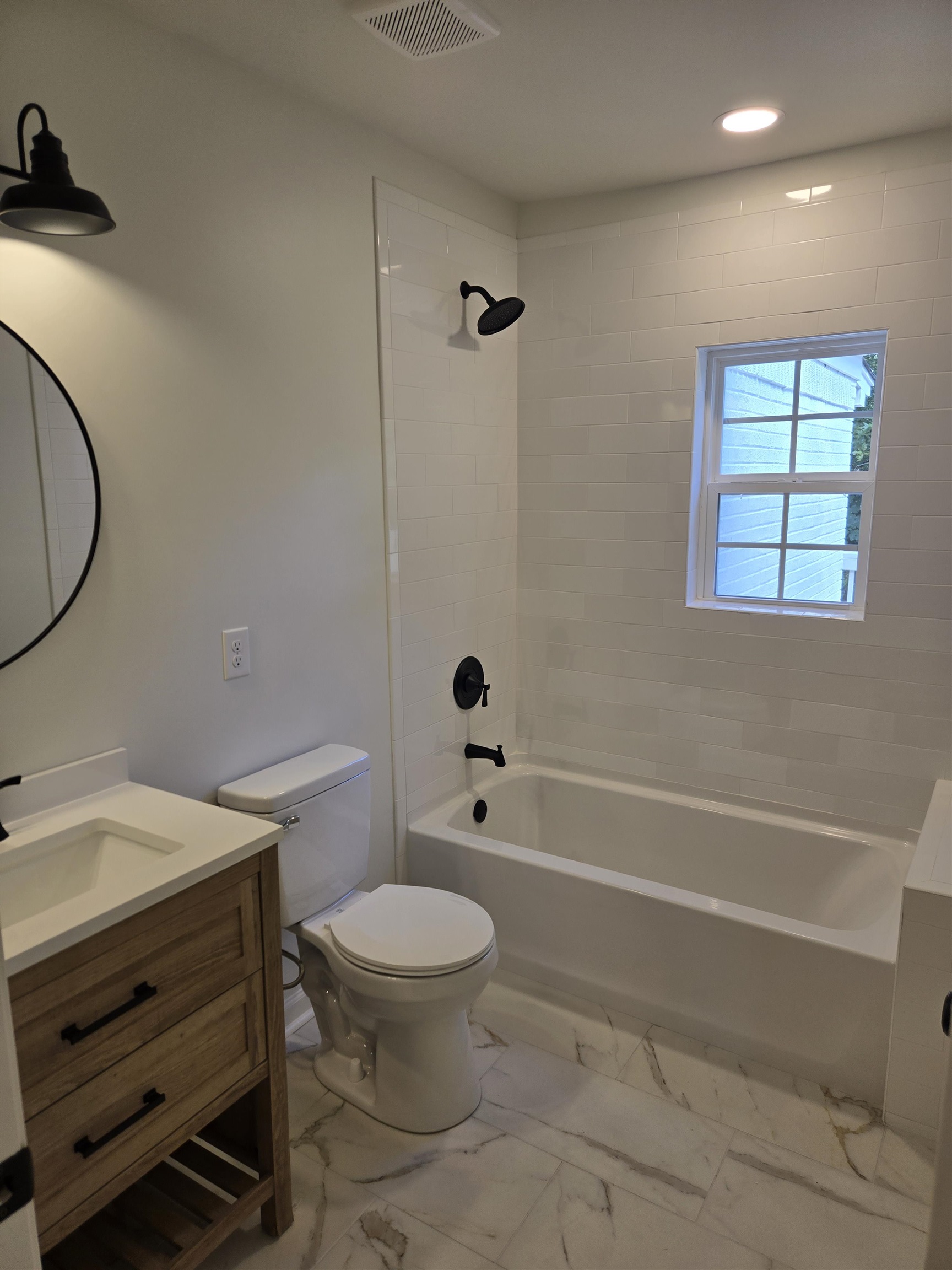 880 Pisgah Road Eads, TN 38028 - Photo 6 of 19 Bathroom featuring washtub / shower combination, vanity, light marble finish flooring, and recessed lighting