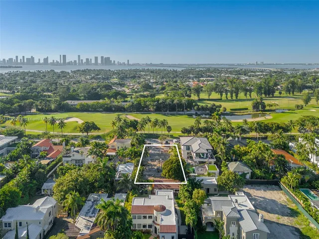 an aerial view of residential houses with outdoor space and swimming pool