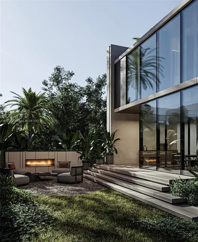 a view of a house with a backyard and sitting area