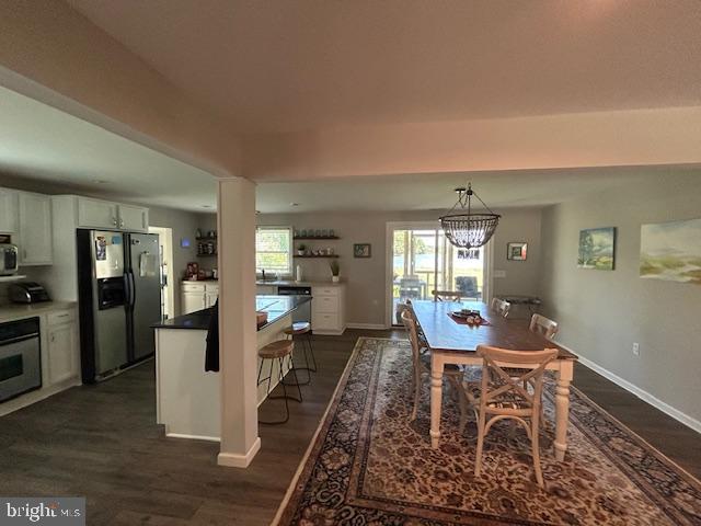 8090 Bozman Neavitt Road St. Michaels, MD 21663 - Photo 22 of 33 a living room with furniture a dining table and wooden floor