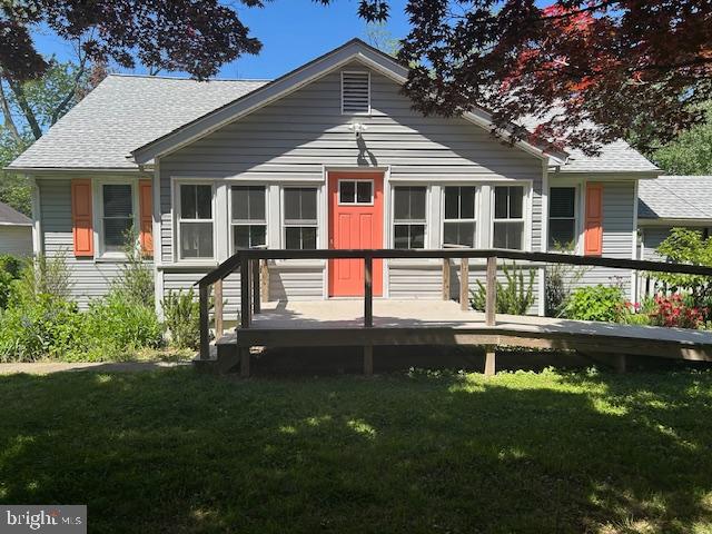 8090 Bozman Neavitt Road St. Michaels, MD 21663 - Photo 27 of 33 a front view of a house with a yard table and chairs