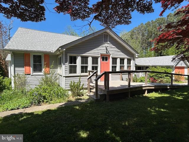 8090 Bozman Neavitt Road St. Michaels, MD 21663 - Photo 28 of 33 a front view of a house with a yard table and chairs
