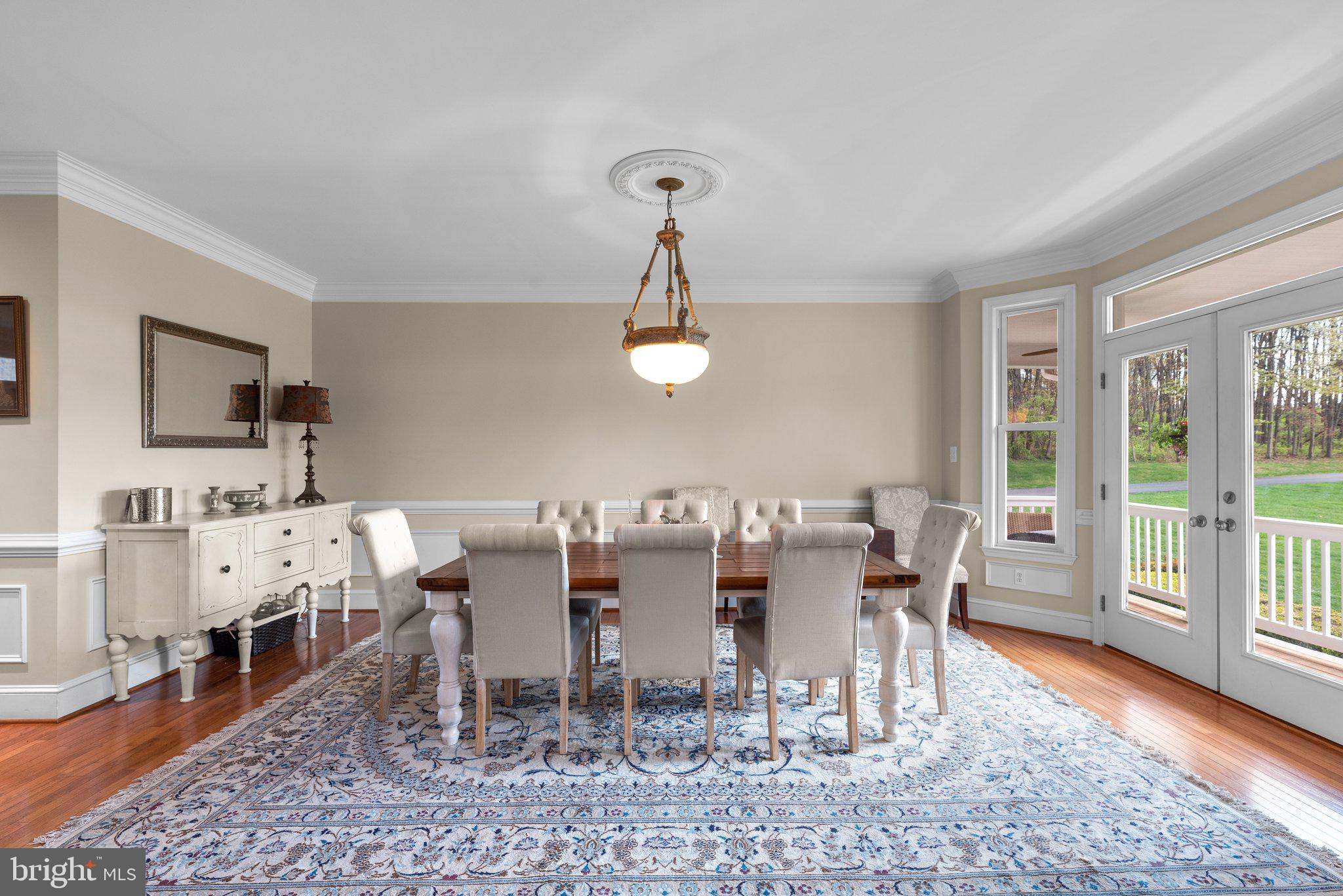 10855 Bethesda Church Road Damascus, MD 20872 - Photo 12 of 92 a dining room with wooden floor a chandelier a wooden table and chairs