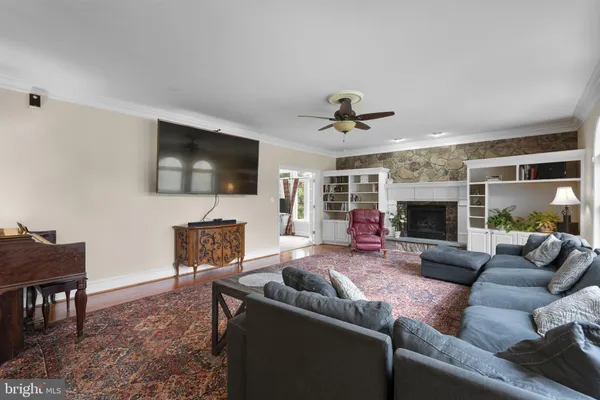 a view of a livingroom with wooden floor and stairs