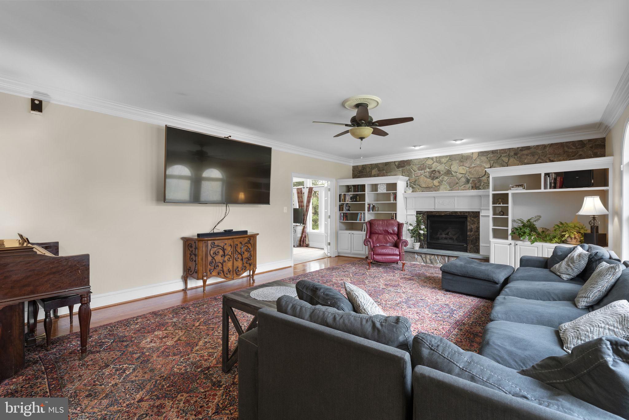 10855 Bethesda Church Road Damascus, MD 20872 - Photo 24 of 92 a living room with furniture a fireplace a flat screen tv and a fireplace