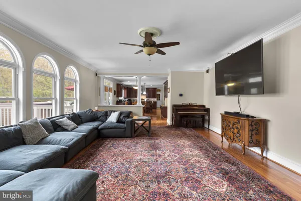 a spacious bedroom with a bed couch and window