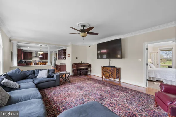 a spacious bedroom with a bed and a flat screen tv