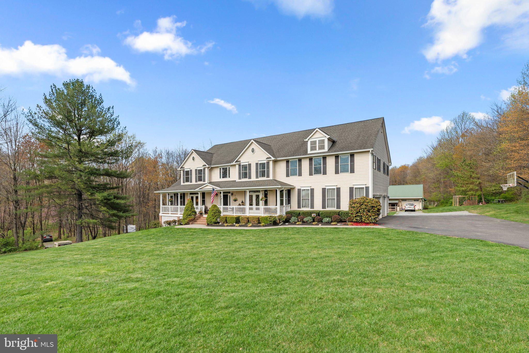 10855 Bethesda Church Road Damascus, MD 20872 - Photo 3 of 92 a view of a house next to a big yard with large trees