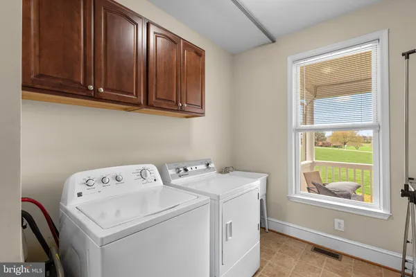 a bathroom with a tub a window and a shower