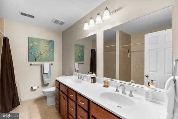 a bathroom with a shower a toilet and a sink