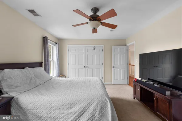 a spacious bedroom with two beds and a window