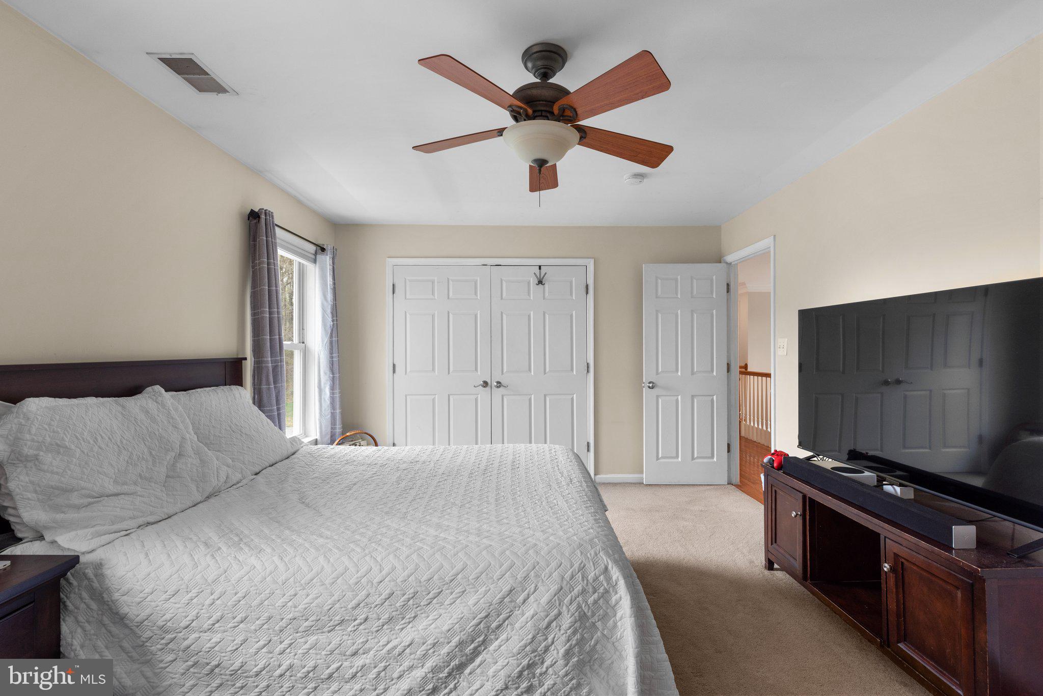 10855 Bethesda Church Road Damascus, MD 20872 - Photo 42 of 92 a bedroom with a bed and a flat screen tv