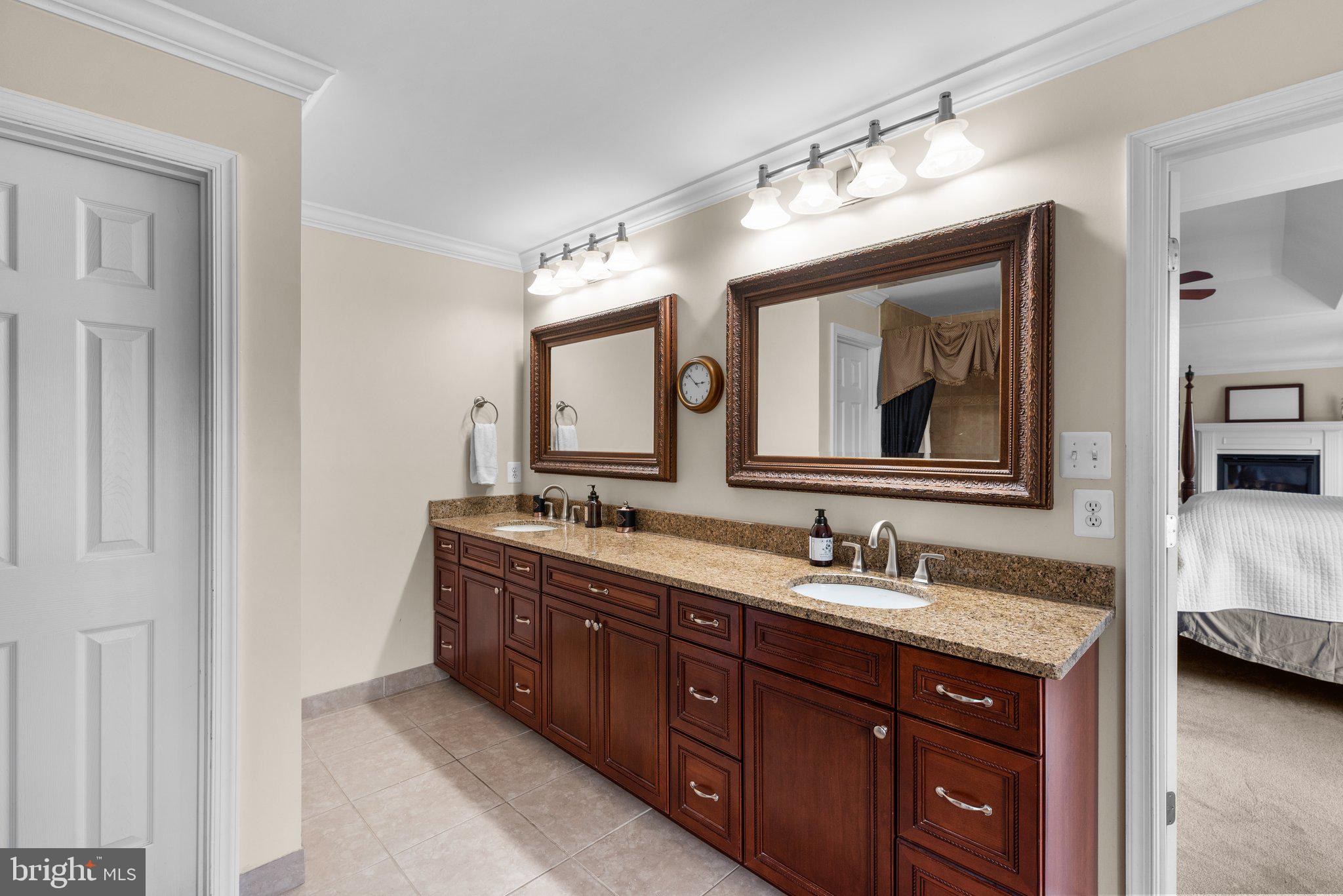 10855 Bethesda Church Road Damascus, MD 20872 - Photo 49 of 92 a bathroom with a double vanity sink and a mirror