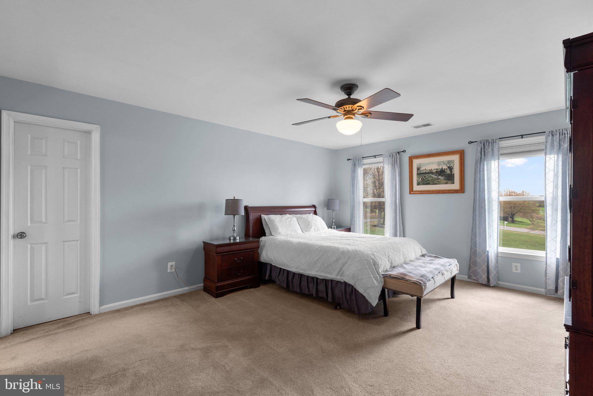 10855 Bethesda Church Road Damascus, MD 20872 - Photo 52 of 92 a spacious bedroom with a bed and a chandelier